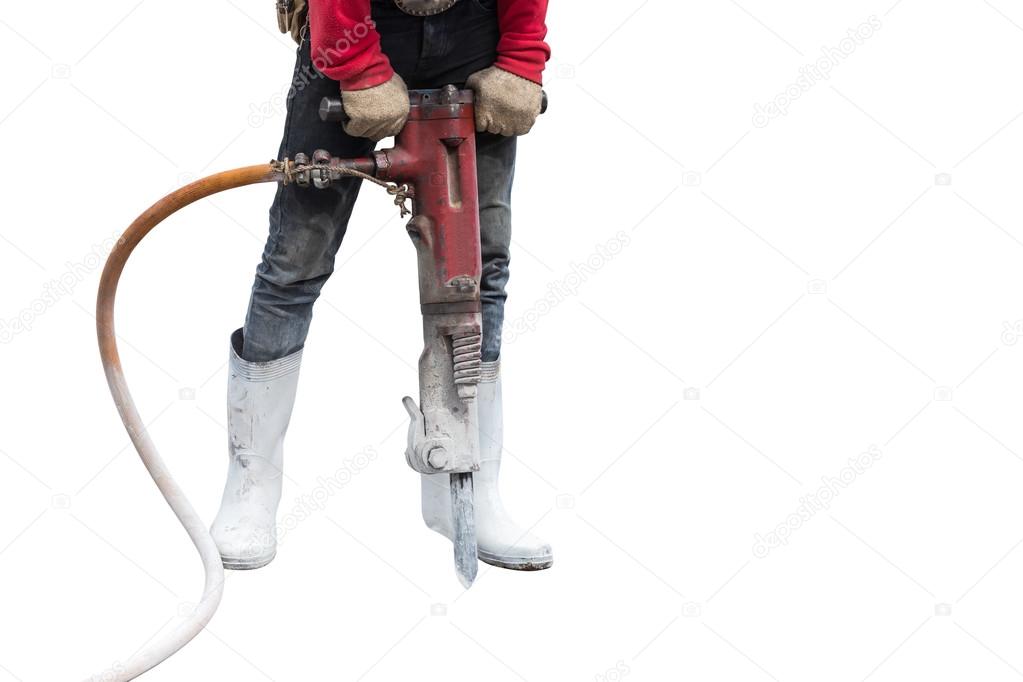 Construction worker removes excess concrete with drilling machin