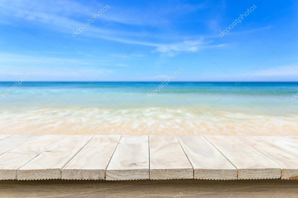Empty top of wooden table and view of tropical beach background 