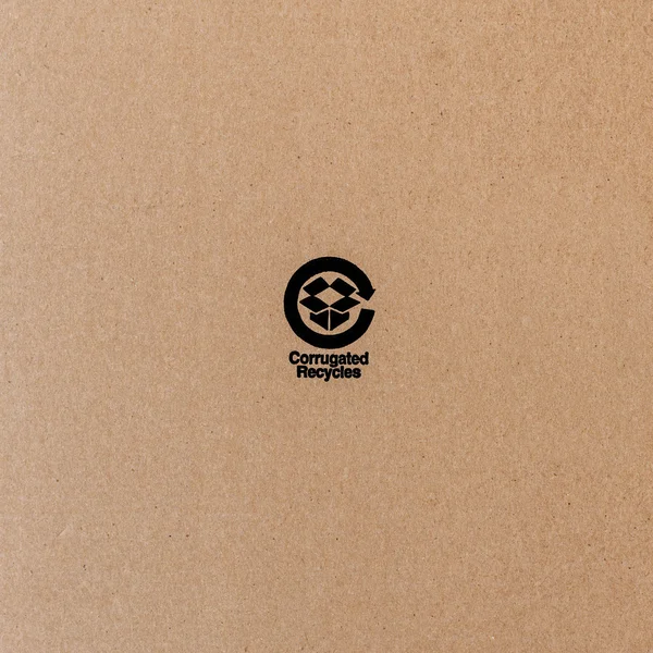 Black recycle symbol on cardboard — Stock Photo, Image