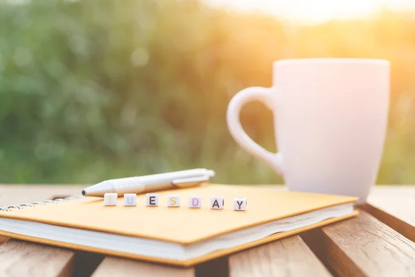 Tuesday written in letter beads and a coffee cup on table — Stock Photo, Image