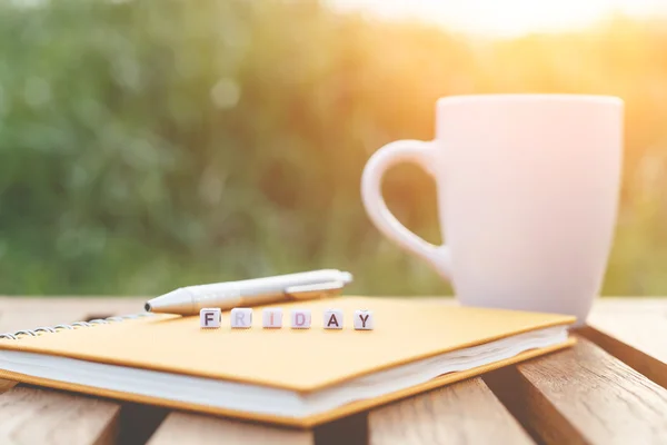 Friday written in letter beads and a coffee cup on table — Stock Photo, Image