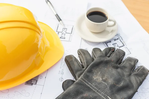 Guante negro de trabajo de primer plano con café, casco de seguridad y piso p — Foto de Stock