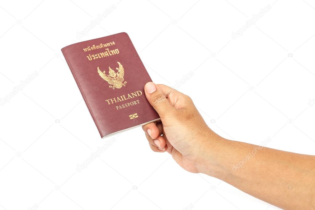 Hand holding Thailand passport isolated on white background