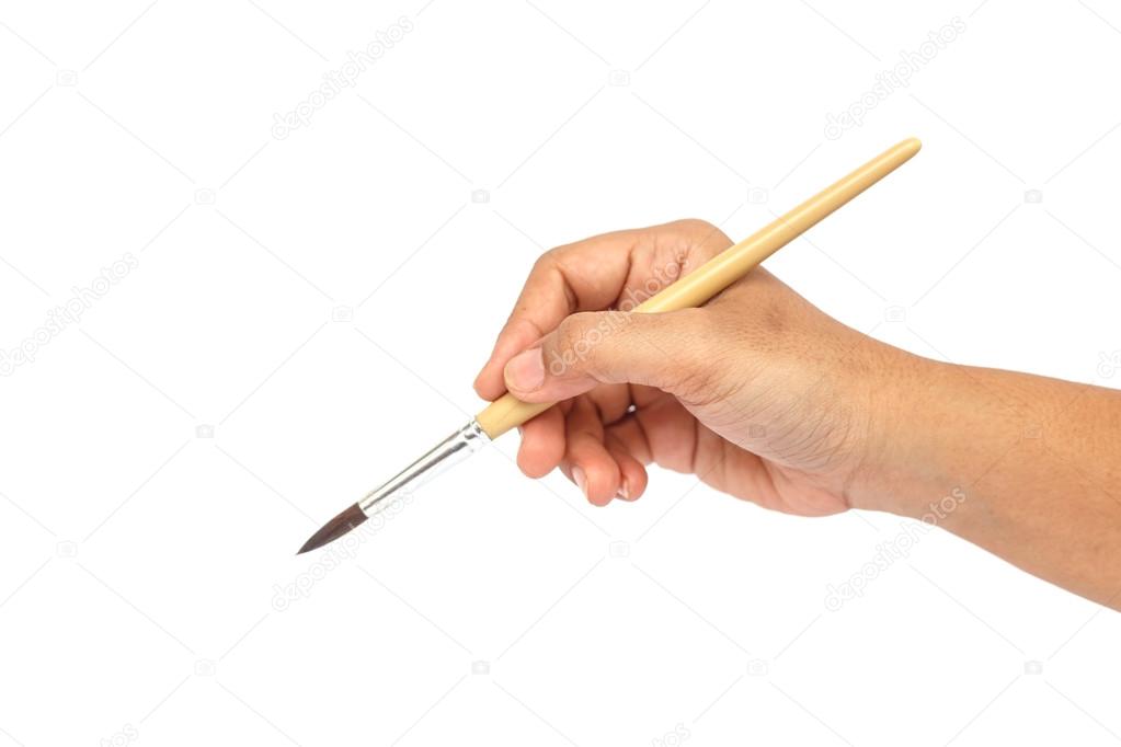 Hand holding paintbrush isolated on white backgroun