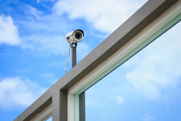 Cámara de seguridad sobre fondo azul cielo — Foto de Stock