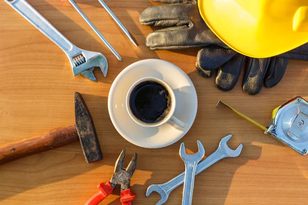 Close up coffee cup and assorted work tools on table — Stock Photo, Image