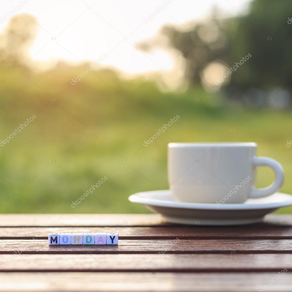 Monday written in letter beads and a coffee cup on table