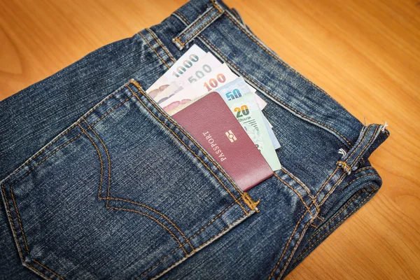 Passport and money in denim jeans pocket — Stock Photo, Image