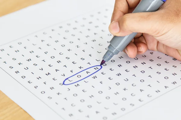 Crossword puzzle close-up.Hand doing crossword — Stock Photo, Image