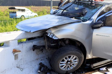 Car accident on the road and crashed into a concrete bridge which causing the driver serious injury. june 27, 2014 in phang nag thailand. clipart