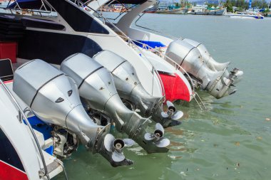 Speed boats stand at the harbor to do service transport for tourist from Phuket to island on July 27, 2014 in Phuket, Thailand. clipart