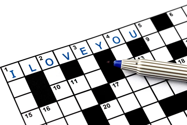 I love you in solving crossword puzzle, close up — Stock Photo, Image