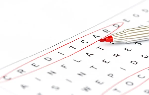 Creditcard in solving crossword puzzle, close up — Stock Photo, Image