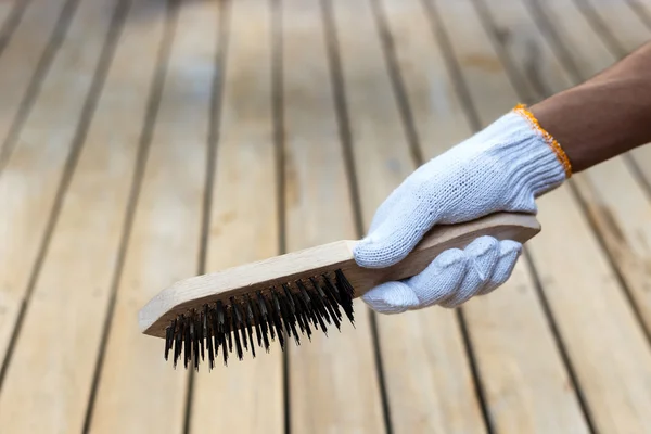 Hand holding steel brush — Stock Photo, Image