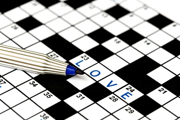 Love in solving crossword puzzle, close up