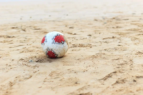 Close-up of male foot playing football on sand — Stock Photo, Image