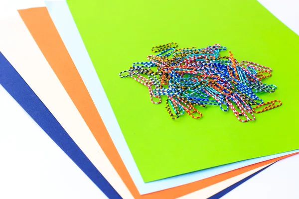 Clipe de papel sobre papel colorido — Fotografia de Stock