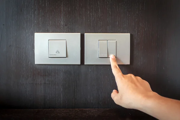 Hand pressing electronic-light switch — Stock Photo, Image