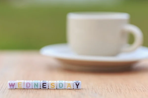 Letter beads and a coffee cup on table — Stock Photo, Image