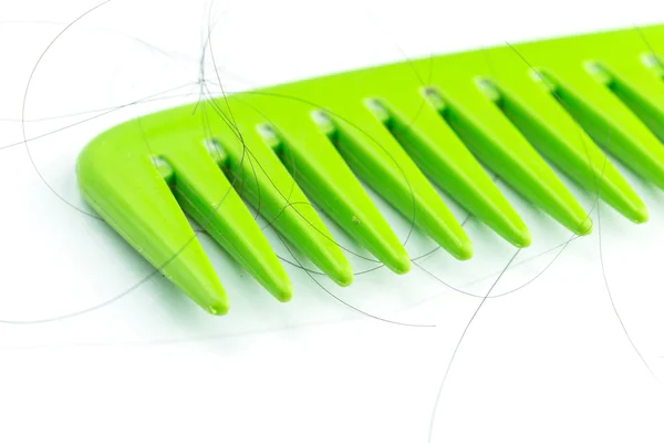 Green comb with hair — Stock Photo, Image