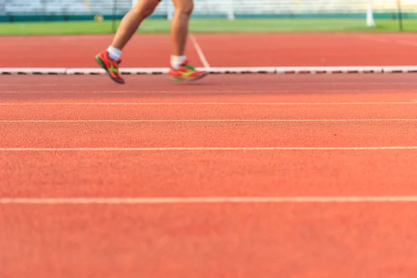 Running track with runner feet — Stock Photo, Image