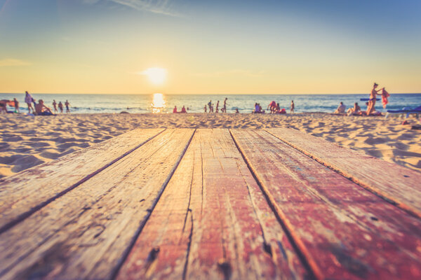 Wooden table at sunset beach Stock Image