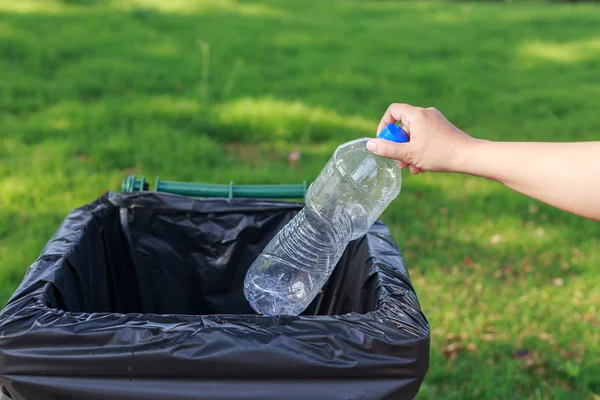 Hand throwing plastic bottle — Stock Photo, Image