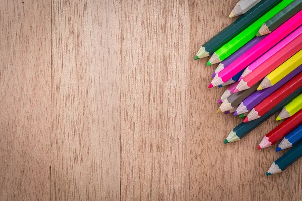 Stack colour pencils on wooden background — Stock Photo, Image