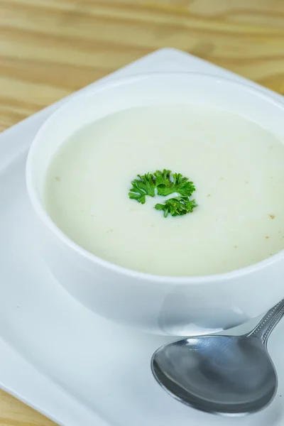 Cream soup in white bowl on wooden table — Stock Photo, Image