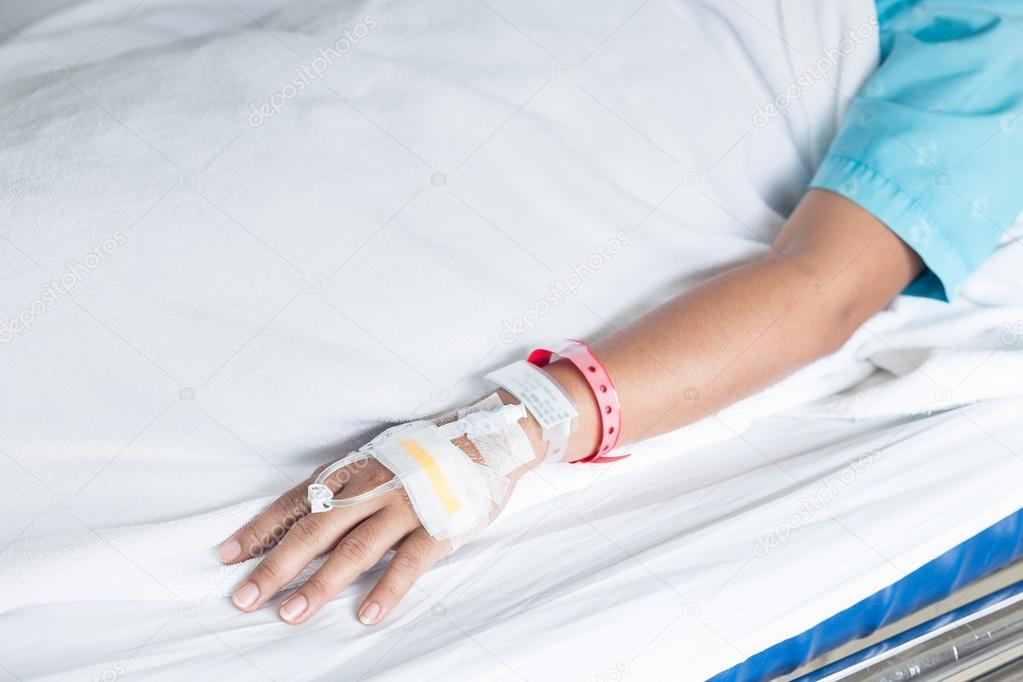 Hand of female patient with IV drip needle piercing in hospital — Stock