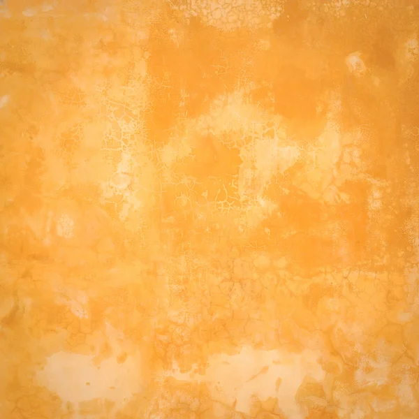Абстрактная оранжевая цементная стена с трещинами текстуры — стоковое фото
