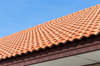 Kırmızı kiremit çatı ve mavi gökyüzü arka plan