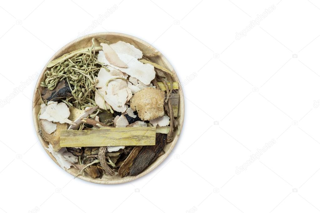Mix of chinese herbal medicine in wooden dish isolated on white 