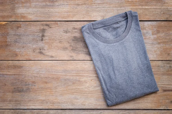 Top view of color T-Shirt on grey wood plank — Stock Photo, Image