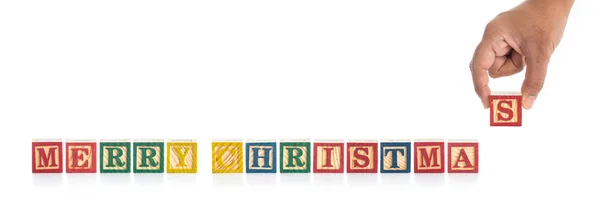 "MERRY CHRISTMAS" write in colorful wood alphabet blocks and han — Stock Photo, Image