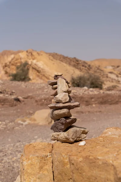 Stacked rocks at Red Canyon in southern Israel. Cairna mound of rough stones built as a memorial or landmark, typically on a hilltop or skyline.