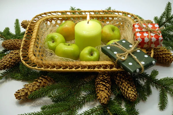 Composition Wicker Basket Green Apples Candle Gifts Fir Branches Cones — Stock Photo, Image