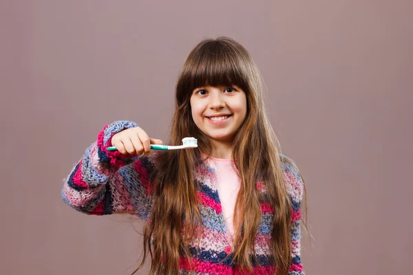 Niña sosteniendo cepillo de dientes — Foto de Stock