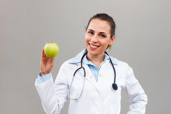 Woman doctor with apple — Stock Photo, Image