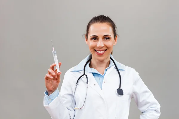 Beautiful female doctor holding injection — Stock Photo, Image