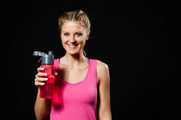 Woman is drinking water after exercise. — Stock Photo, Image