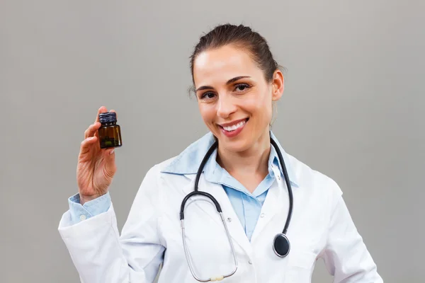 Female doctor holding bottle of pills — Stock Photo, Image