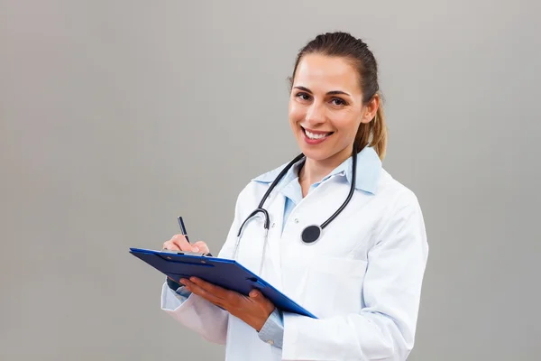 Doctor woman with clipboard Stock Image