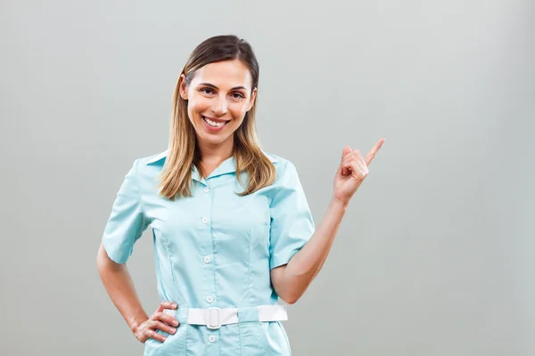 Smiling nurse pointing — Stock Photo, Image