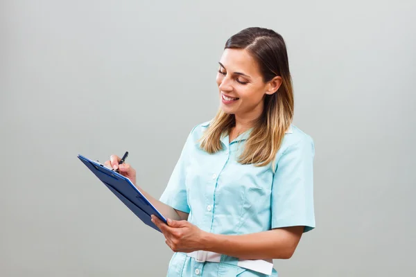 Doctor nurse with clipboard — Stock Photo, Image