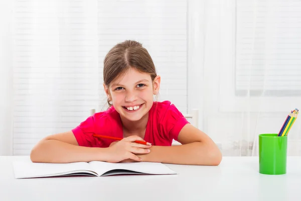 Little girl drawing and writing Stock Photo