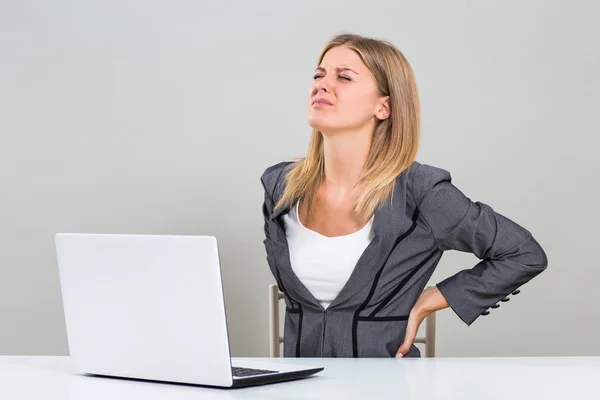 Young businesswoman has back pain — Stock Photo, Image