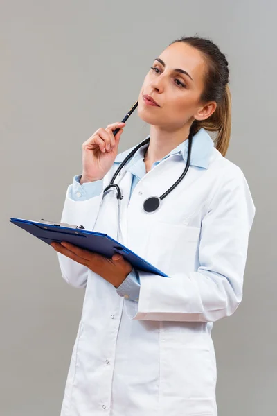 Thinking woman doctor — Stockfoto