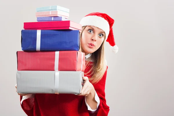 Girl in Santa's hat with Christmas gifts — Stock Photo, Image