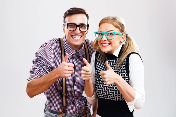 Nerdy couple showing thumbs up — Stock Photo, Image